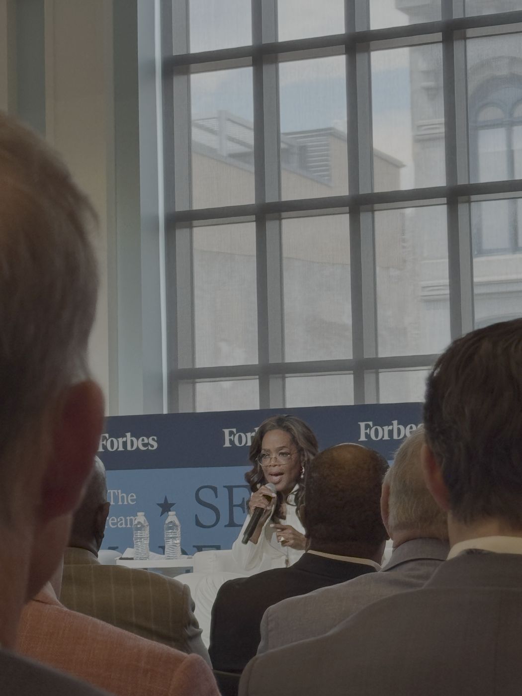 Oprah speaking on stage at Self-Made 250